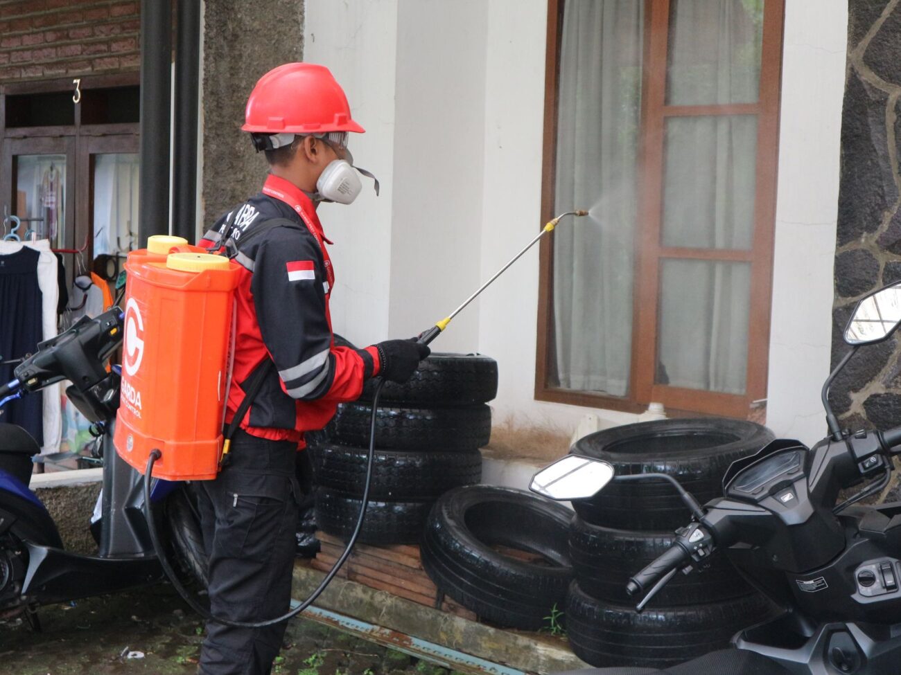 man in helmet spraying tires