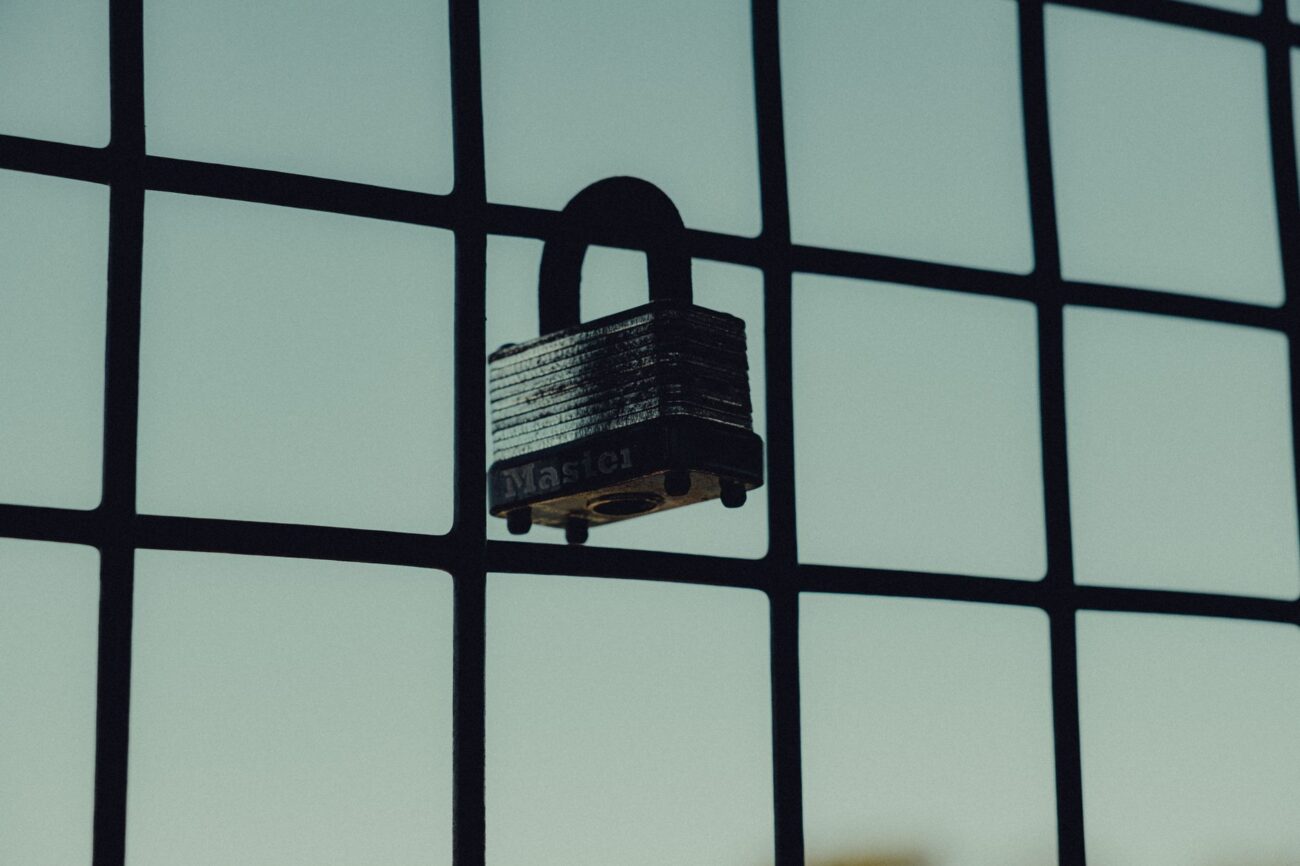 pexels-photo-15049670 - iDevice Central padlock hanging on mesh fence